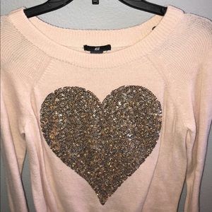 pink sweater with a gold, sequin heart